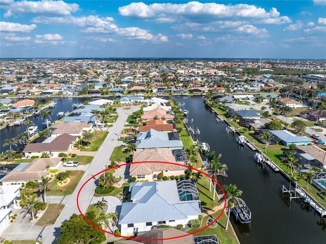 drone / aerial view with a residential view and a water view