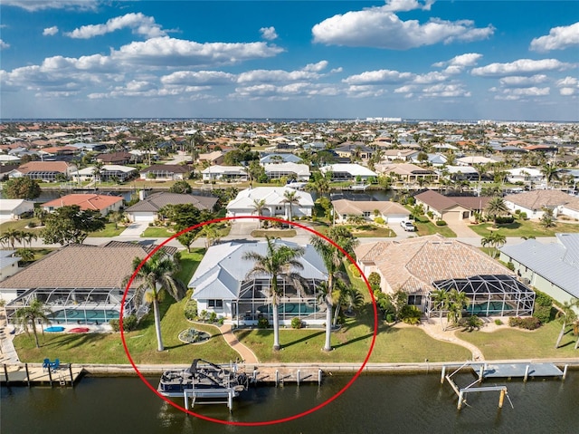 birds eye view of property featuring a residential view and a water view