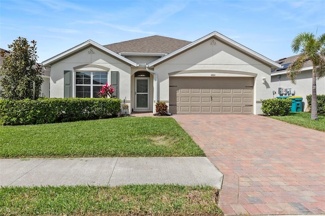 single story home with a garage, roof with shingles, decorative driveway, stucco siding, and a front yard