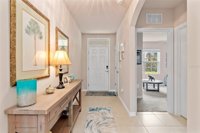 foyer entrance featuring visible vents, baseboards, and light tile patterned floors