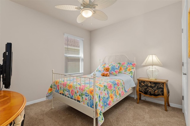 carpeted bedroom featuring a ceiling fan and baseboards