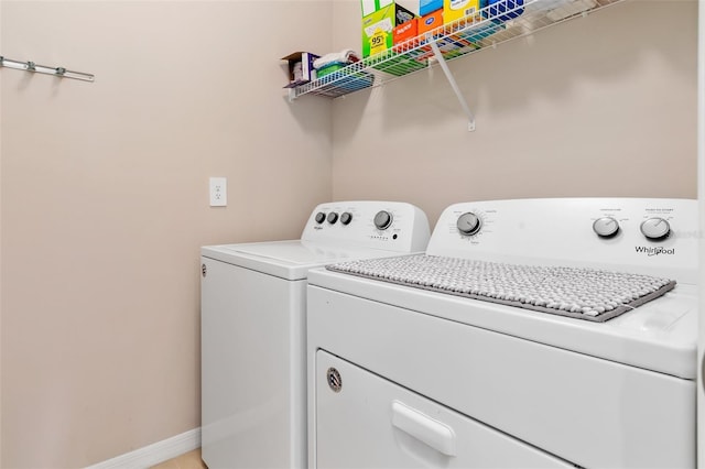 laundry area featuring laundry area, baseboards, and separate washer and dryer