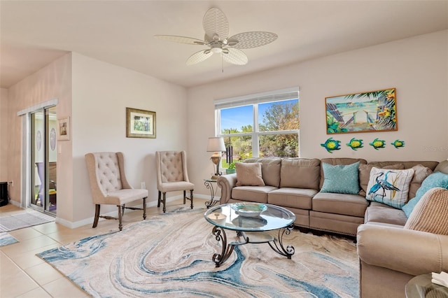 living room with baseboards, a ceiling fan, and light tile patterned flooring