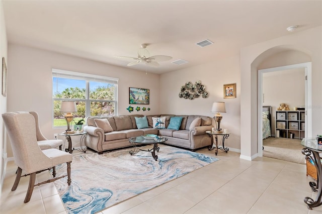 living room featuring visible vents, ceiling fan, baseboards, and light tile patterned flooring