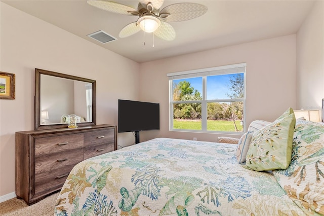 bedroom featuring carpet floors, baseboards, visible vents, and a ceiling fan