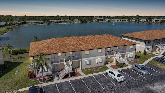 birds eye view of property with a water view