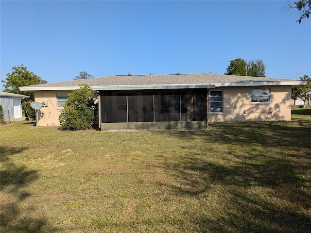 back of property featuring a sunroom and a yard