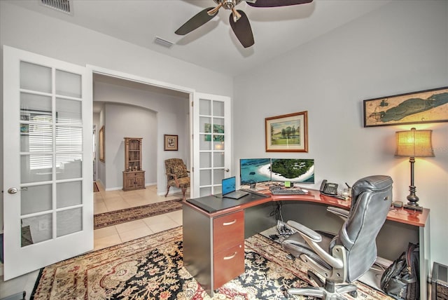 tiled home office with ceiling fan, visible vents, and french doors