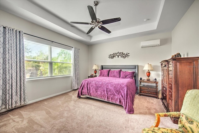 carpeted bedroom with a ceiling fan, a raised ceiling, a wall unit AC, and baseboards