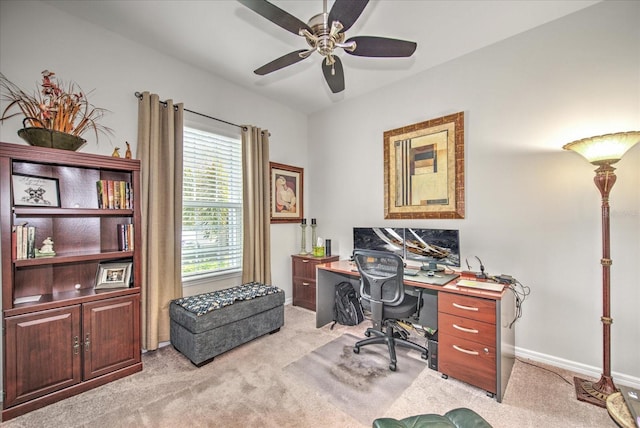 office space featuring a ceiling fan, light carpet, and baseboards