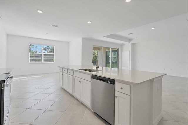 kitchen featuring open floor plan, a healthy amount of sunlight, a sink, and stainless steel dishwasher