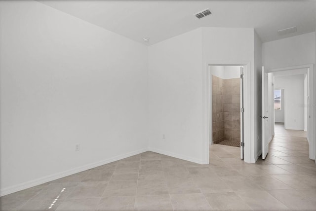 spare room featuring visible vents, baseboards, and light tile patterned flooring