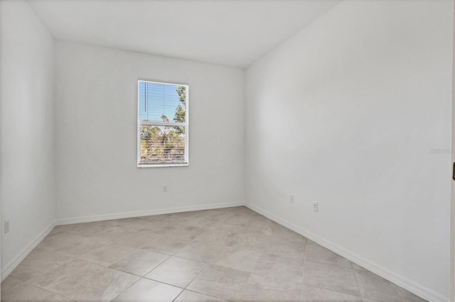 spare room featuring baseboards