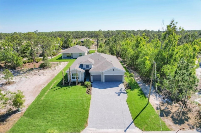 drone / aerial view featuring a view of trees