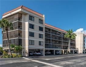 view of building exterior with uncovered parking