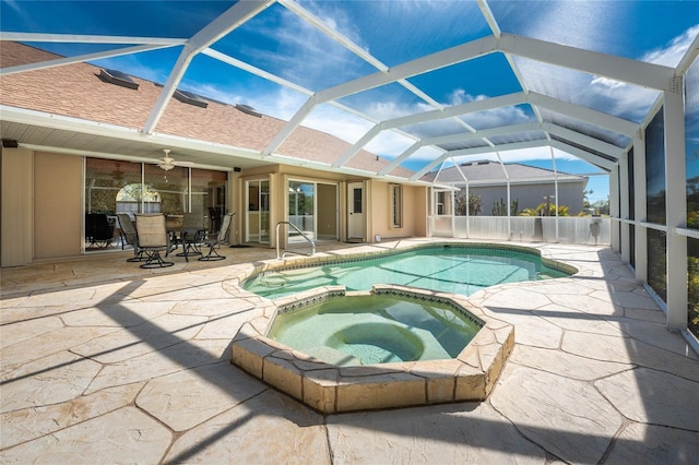 view of swimming pool with ceiling fan, a patio area, a lanai, and a pool with connected hot tub