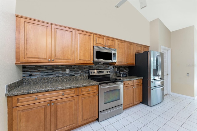 16571 Cape Horn Blvd, Punta Gorda, FL 33955 - kitchen featuring high vaulted ceiling, tasteful backsplash, appliances with stainless steel finishes, brown cabinetry, and light tile patterned floors