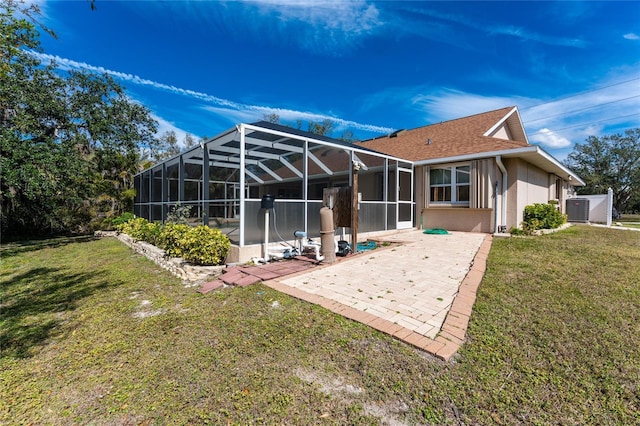 16571 Cape Horn Blvd, Punta Gorda, FL 33955 - rear view of property with central AC, a yard, a shingled roof, a lanai, and a patio area