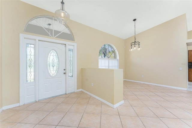 16571 Cape Horn Blvd, Punta Gorda, FL 33955 - entrance foyer featuring light tile patterned floors, baseboards, an inviting chandelier, and vaulted ceiling