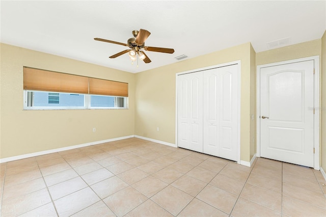 16571 Cape Horn Blvd, Punta Gorda, FL 33955 - unfurnished bedroom featuring visible vents, baseboards, light tile patterned floors, a closet, and a ceiling fan