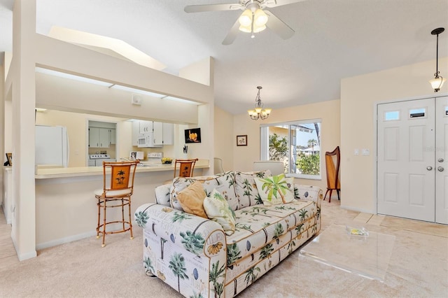 living room with lofted ceiling, baseboards, and ceiling fan with notable chandelier