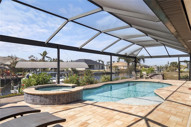 view of pool with glass enclosure, a patio area, a pool with connected hot tub, and a water view