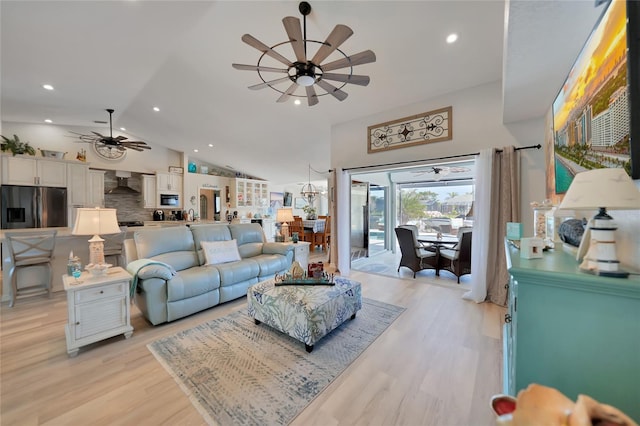 living area featuring ceiling fan, vaulted ceiling, light wood-type flooring, and recessed lighting