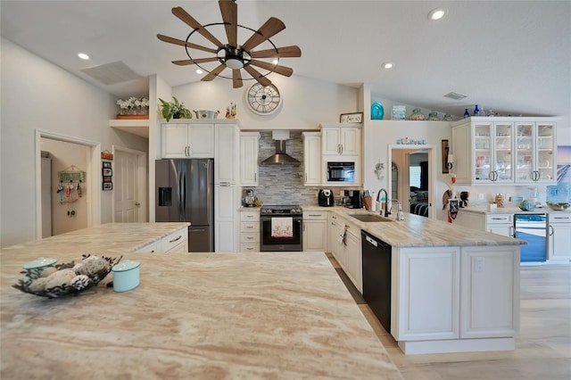 kitchen featuring range with electric stovetop, a sink, black dishwasher, stainless steel fridge with ice dispenser, and wall chimney exhaust hood