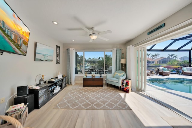 sitting room with recessed lighting, a sunroom, ceiling fan, and wood finished floors