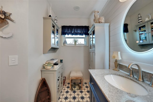 bathroom with baseboards, vanity, and tile patterned floors