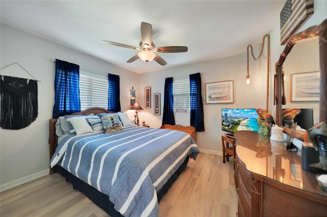 bedroom with ceiling fan, light wood-type flooring, and baseboards