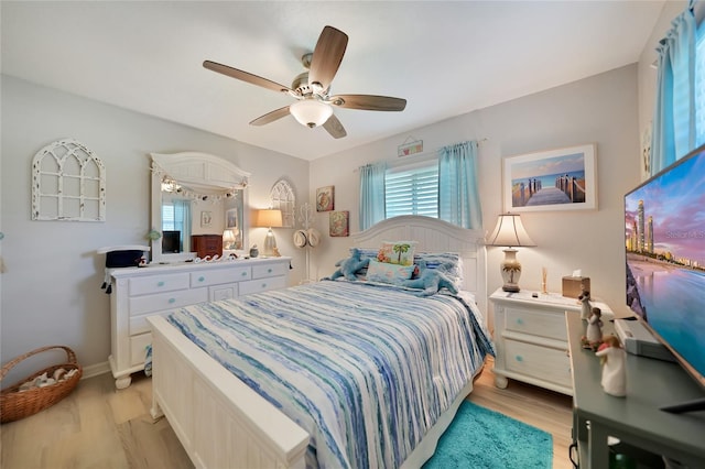 bedroom with light wood-style floors and ceiling fan