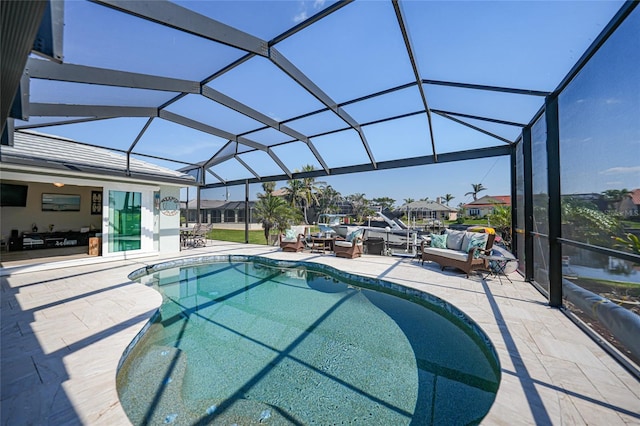 outdoor pool featuring glass enclosure and a patio