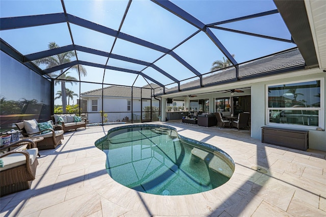 pool featuring glass enclosure, ceiling fan, outdoor lounge area, and a patio