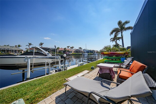 view of patio featuring a dock, a water view, and boat lift