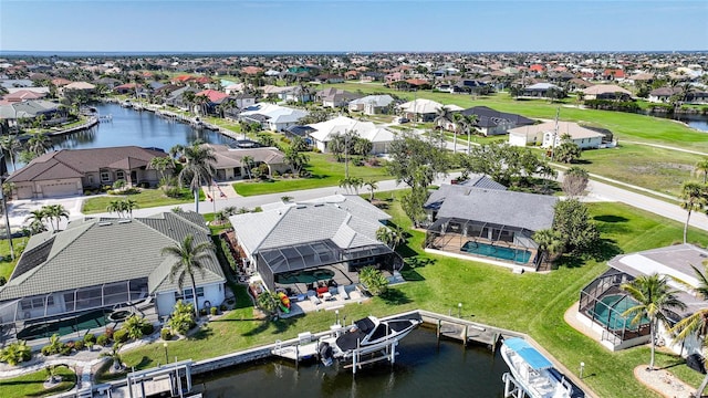 drone / aerial view with a water view and a residential view