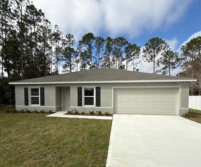 ranch-style home with driveway, a front lawn, an attached garage, and stucco siding