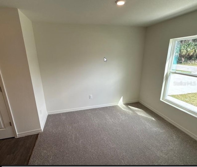 carpeted empty room with baseboards and recessed lighting