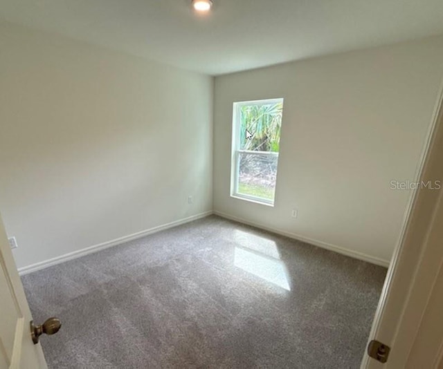 empty room with carpet floors and baseboards