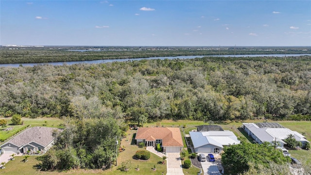 bird's eye view with a water view and a wooded view