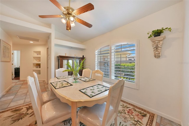 dining room featuring vaulted ceiling, a ceiling fan, and baseboards