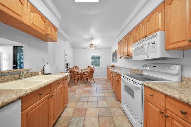 kitchen with ceiling fan, white appliances, a sink, baseboards, and vaulted ceiling