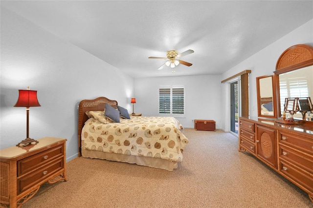 bedroom featuring light carpet, ceiling fan, and baseboards