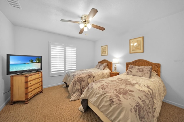 bedroom with baseboards, visible vents, and light colored carpet