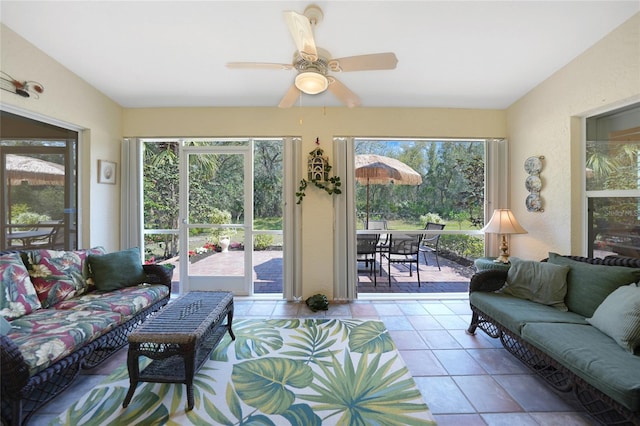 tiled living room with a ceiling fan and a wealth of natural light