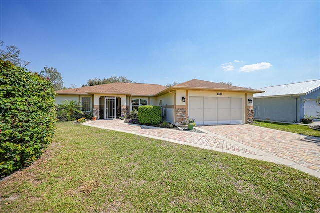 view of front of home featuring decorative driveway, stucco siding, a garage, stone siding, and a front lawn