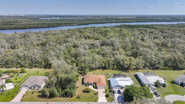 aerial view featuring a water view and a wooded view