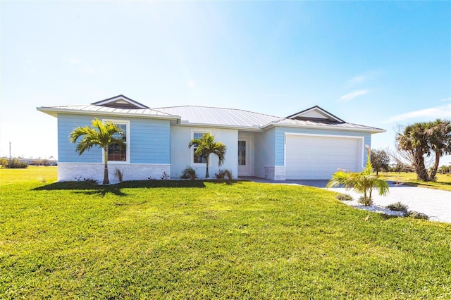 ranch-style home featuring metal roof, driveway, a front lawn, and an attached garage