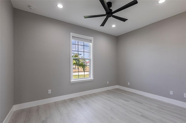 spare room featuring light wood-style flooring, baseboards, and recessed lighting