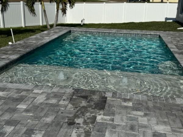 view of pool with a patio, a fenced backyard, and a fenced in pool